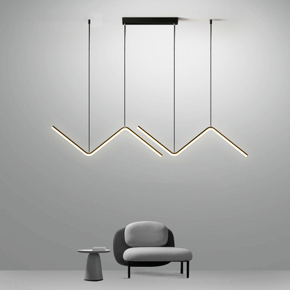 Lustre pendente moderno em LED com design tubular em ziguezague dourado em sala minimalista cinza com poltrona e mesa lateral