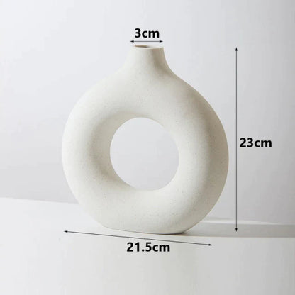 Vaso decorativo moderno branco em formato circular com dimensões 23x21,5x3 cm sobre superfície branca